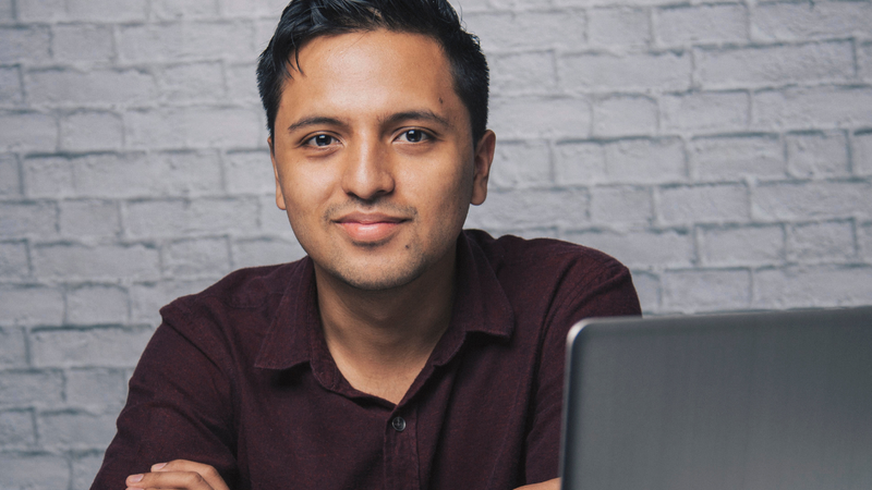 Man sat at his computer to fill out the Family Medical History form to become a Semovo sperm donor